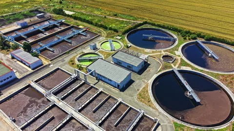 Water treatment facility operates with several large tanks for processing water 库存影片 339518404