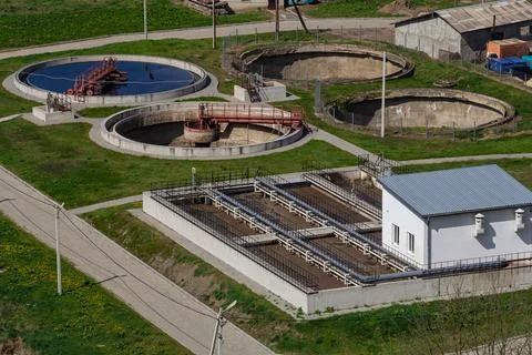 Water treatment facility in operation with multiple tanks and pathways in a.. Stock Photos