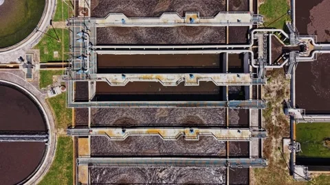 Water treatment facility process seen from above with different tanks Video stock 339058969