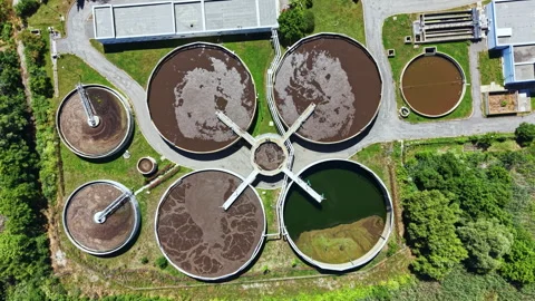 Water treatment facility processes waste materials in outdoor setting near trees Vidéo 337908843
