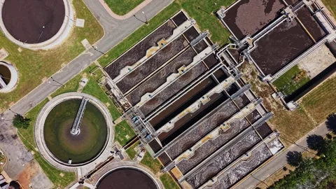 Water treatment facility processes wastewater in a large plant Stockbeeldmateriaal 339058780