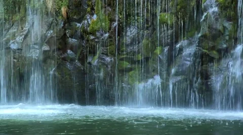 Water trickling down mossy rocks Stock Footage 55012603