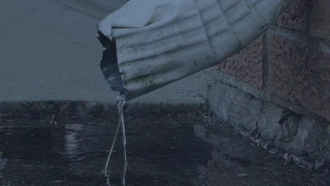 Water trickling out of a gutter in slow motion (120fps at 24) Stock Footage 86567232