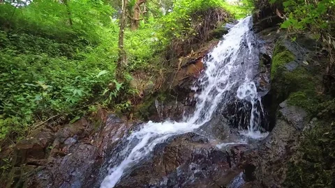 Water Tumbles over Waterfall in Dramatic Slow Motion Stockbeeldmateriaal 87838508