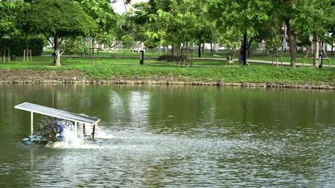 Water turbine using solar panel cell is treating water in a park pool. Stock Footage 278289948