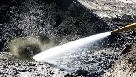 Water under pressure comes out of the pneumatic hydrant and blurs a pile of sand Stock Footage 80271879