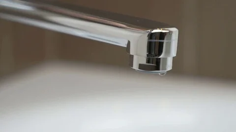 Water under weak pressure flows from a water tap Stock Footage 71509197
