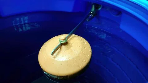 Water Valve Float Buoyantly Regulating Level in a Tranquil Blue Tank Stock Photos