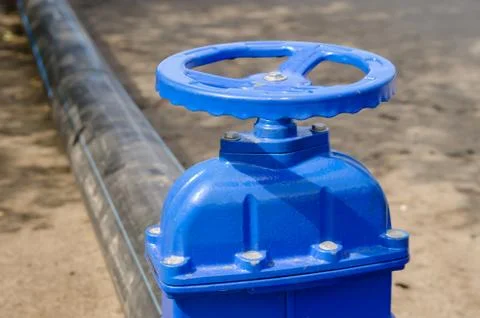 A water valve on a pipe that drains excess water. sewer cleaning Foto stock