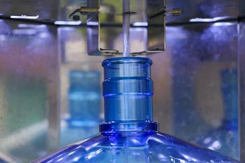 Water vending machine refilling plastic jug, closeup Stock Photos