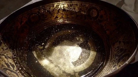 Water is vibrating inside copper bowl in nada therapy session, oscillations is Stock Footage 99568449