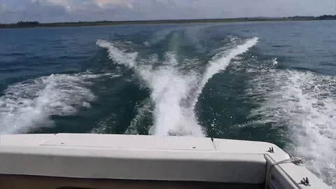 Water wake surface trace behind the fast moving motor speed boat Stock Footage 116675381