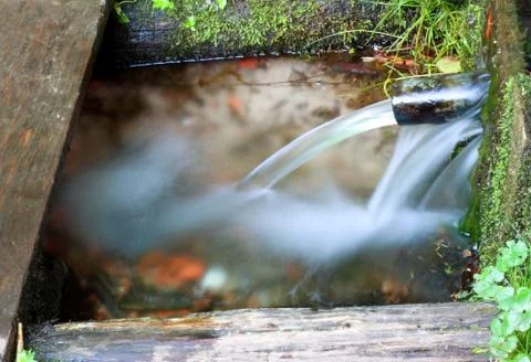 Water was flowing from an underground source, the spring. Stock Photos