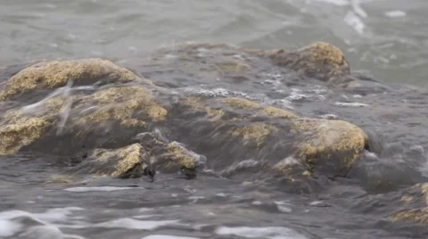 Water washes the stone. Stock Footage 53050595