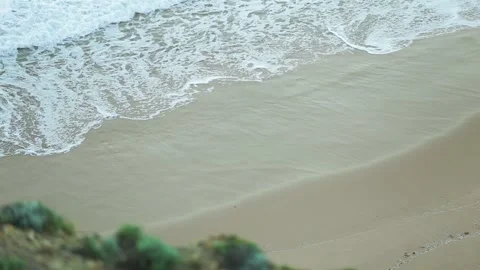 Water washing onto beach Stock Footage 262287033