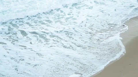 Water washing onto sandy beach Stock Footage 262294568