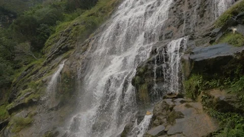 Water from a waterfall flows over the rocks to the river, in China Stock Footage 232156521