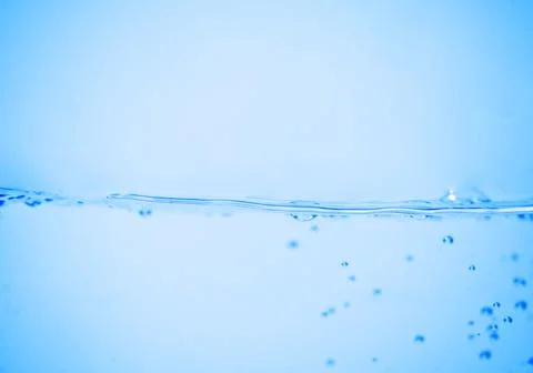 Water wave with bubbles on a white Stock Photos