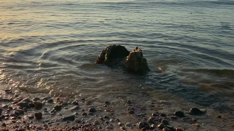 Water wave splashes on rock stone in sea. ripples after splashing water seashore Video stock 170758439