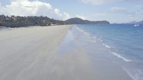 Water waves blue sea on sandy beach view from above. Sea waves splashing on Stock Footage 106436033