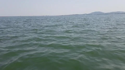 Water Waves on Lake Surface with Distant Hills Stock Footage 333574494