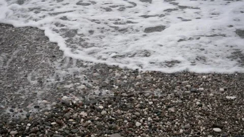 Water waves on the small rocks of the shore Stock Footage 265680694