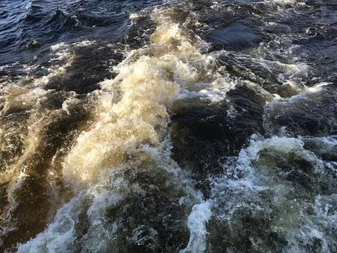 Water waves on the surface of the river, closeup of photo Stock Photos
