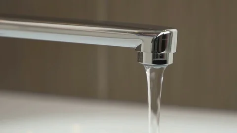 Water weak pressure flows from a water tap Stock Footage 72521741