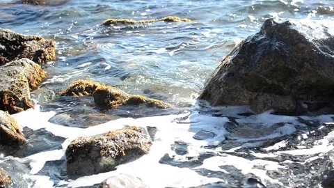 Water wears away a stone sunset sea waves storm stone wild beach 库存影片 99190946