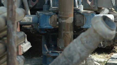 Water well drill rig pulling out drill pipes after drilling water borehole Stock Footage 123420712