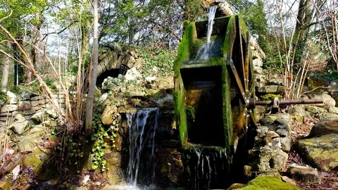 Water wheel of an old-fashioned mill rotating under the pressure of the water Stock Footage 124699710
