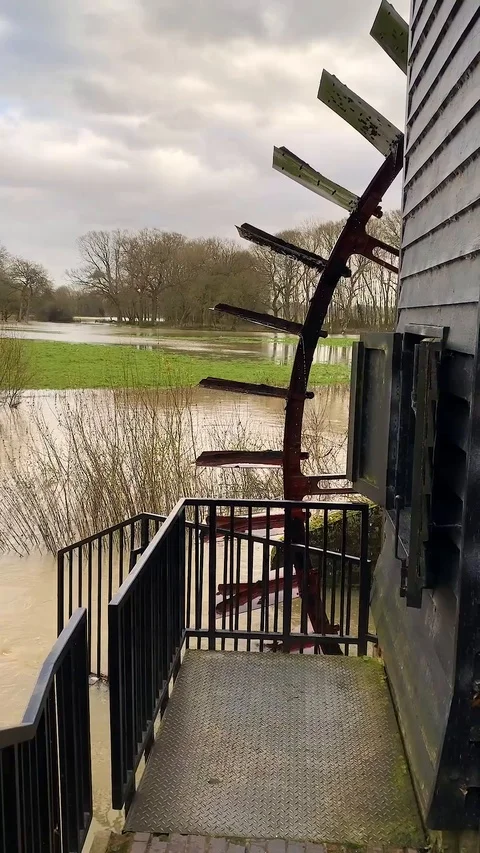 Water Wheel revolving with flooded fields in background. Stock Footage 121501663
