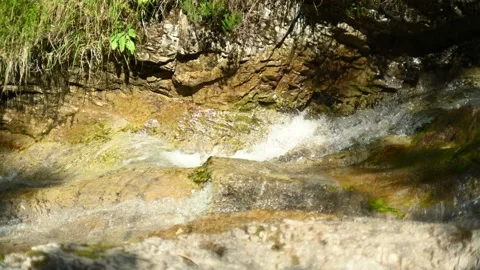 Water from a wild mountain stream flows over rocks 스톡 동영상 211471466