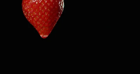 A waterdrop is running down a strawberry Stock Footage 101600644