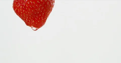 A waterdrop is running down a strawberry Stock Footage 101600781