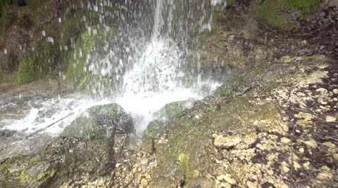 Waterdrops are falling down from a waterfall in slow motion (200fps) Stock Footage 23486306