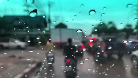 Waterdrops on car windshield, motion movement with traffic in the city on a rain Stock Footage 95027402