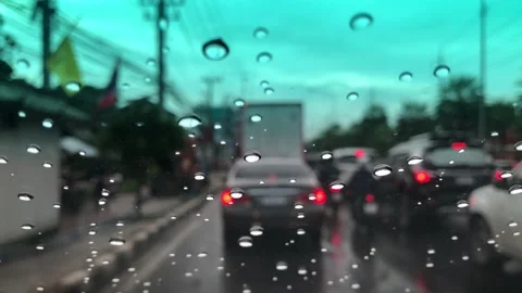 Waterdrops on car windshield, motion movement with traffic in the city on a rain Stock Footage 95027409