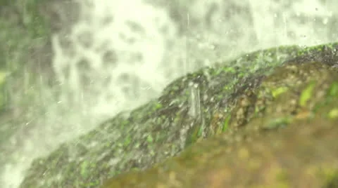 Waterdrops falling on a stone Stock Footage 23483193