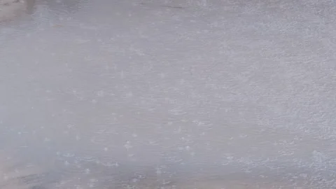 Waterdrops falling on the surface of the puddle Stock Footage 237269416