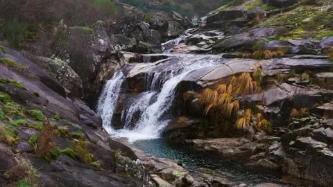 Waterefall From Distance Flowing Down The Rocky Mountain Stock Footage 302917874