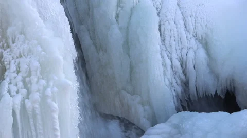 Waterfall among ice on the river in spring Stock Footage 88394980