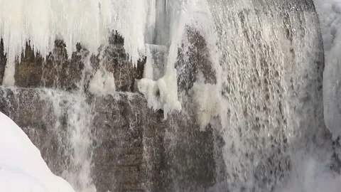 Waterfall among ice on the river in spring Stock Footage 88395180
