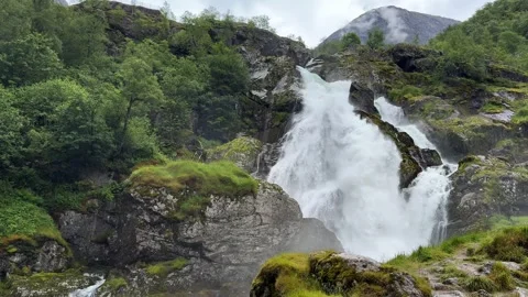 A waterfall among rocks and mountains Stock Footage 337364510