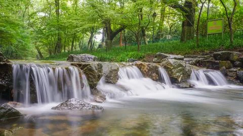 Waterfall and blue stream in the forest nature background for design, China Stock Photos