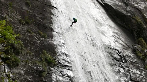 The waterfall and the climber.Alps,Vallemaggia Switzerland. Stock Footage