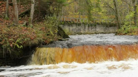 Waterfall and a distant old bridge Stock Footage 10579088