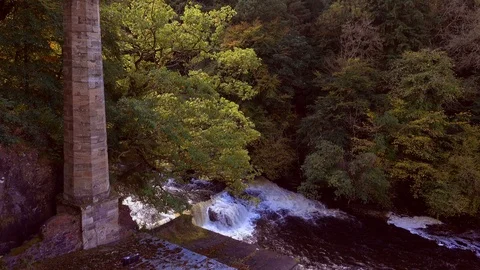 Waterfall and disused chimney stack on the River Clyde close to New Lanark. Stock Footage 95645153