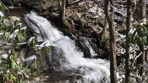 Waterfall and Gently Falling Snow Video stock 139704662