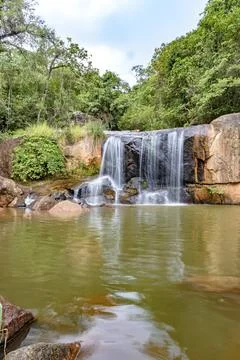 Waterfall and lake in rain forest of Moeda in Minas Gerais state on cloudy day Stock Photos